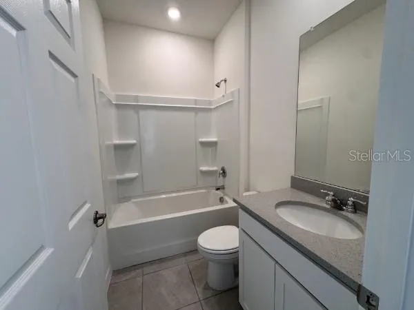 a bathroom with a granite countertop toilet a sink and bathtub