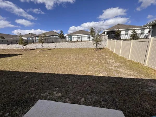 a view of a large building with yard in front of it