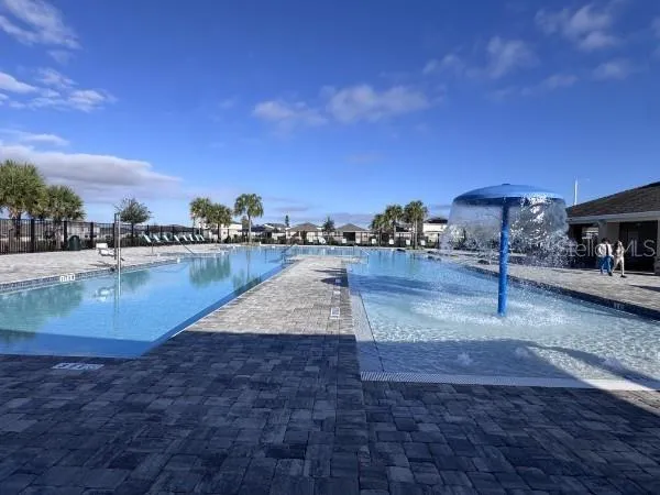 a view of a swimming pool with a yard