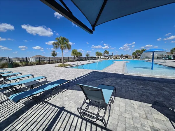 a view of a swimming pool with outdoor seating