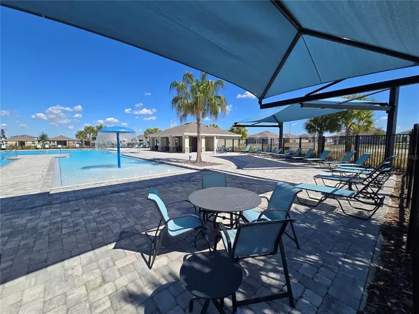 a patio with a table and chairs and a umbrella