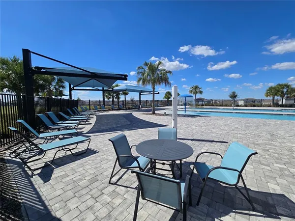 a view of a patio with chairs and tables