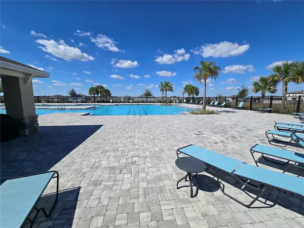 a view of swimming pool with lounge chair