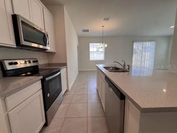 a kitchen with a sink a stove and microwave