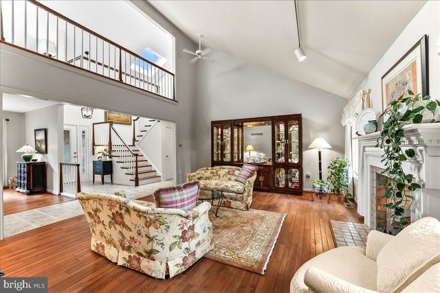 a living room with furniture a rug and a table
