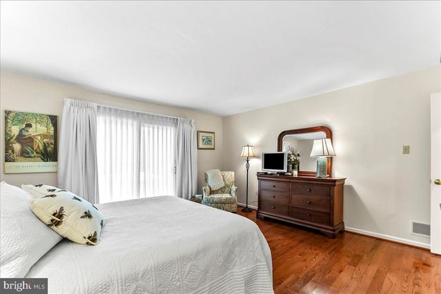 a bathroom with a granite countertop toilet sink and mirror