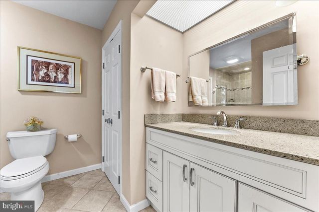 a view of living room with furniture and mirror
