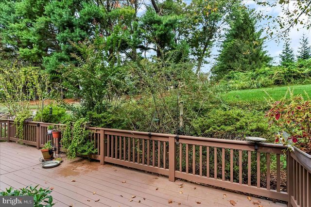 an aerial view of residential house with outdoor space and trees all around