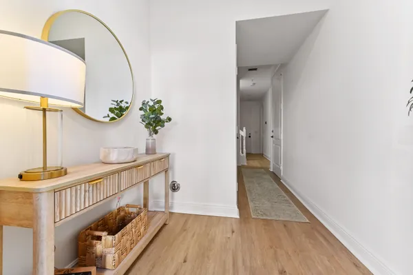a view of a hallway view with wooden floor and staircase