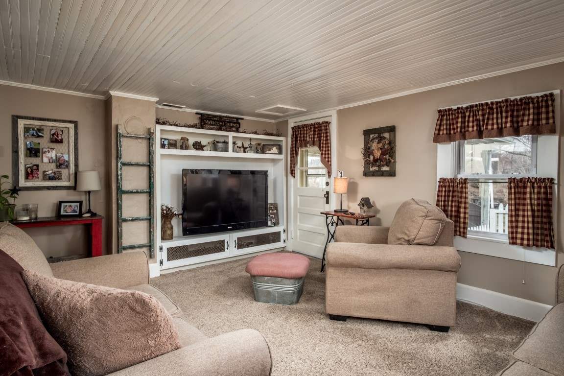 1794 Mt Torrey Road Lyndhurst, VA 22952 - Photo 15 of 44 a living room with furniture a flat screen tv and a floor to ceiling window