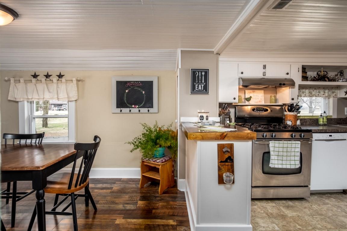 1794 Mt Torrey Road Lyndhurst, VA 22952 - Photo 18 of 44 a kitchen with stainless steel appliances granite countertop a stove top oven a sink a dining table and chairs