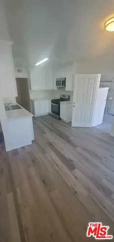 a view of kitchen with wooden floor