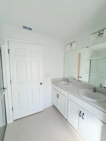 an empty room with windows and a fireplace