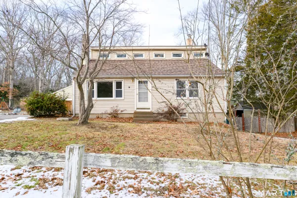 a view of a house with a yard covered in snow