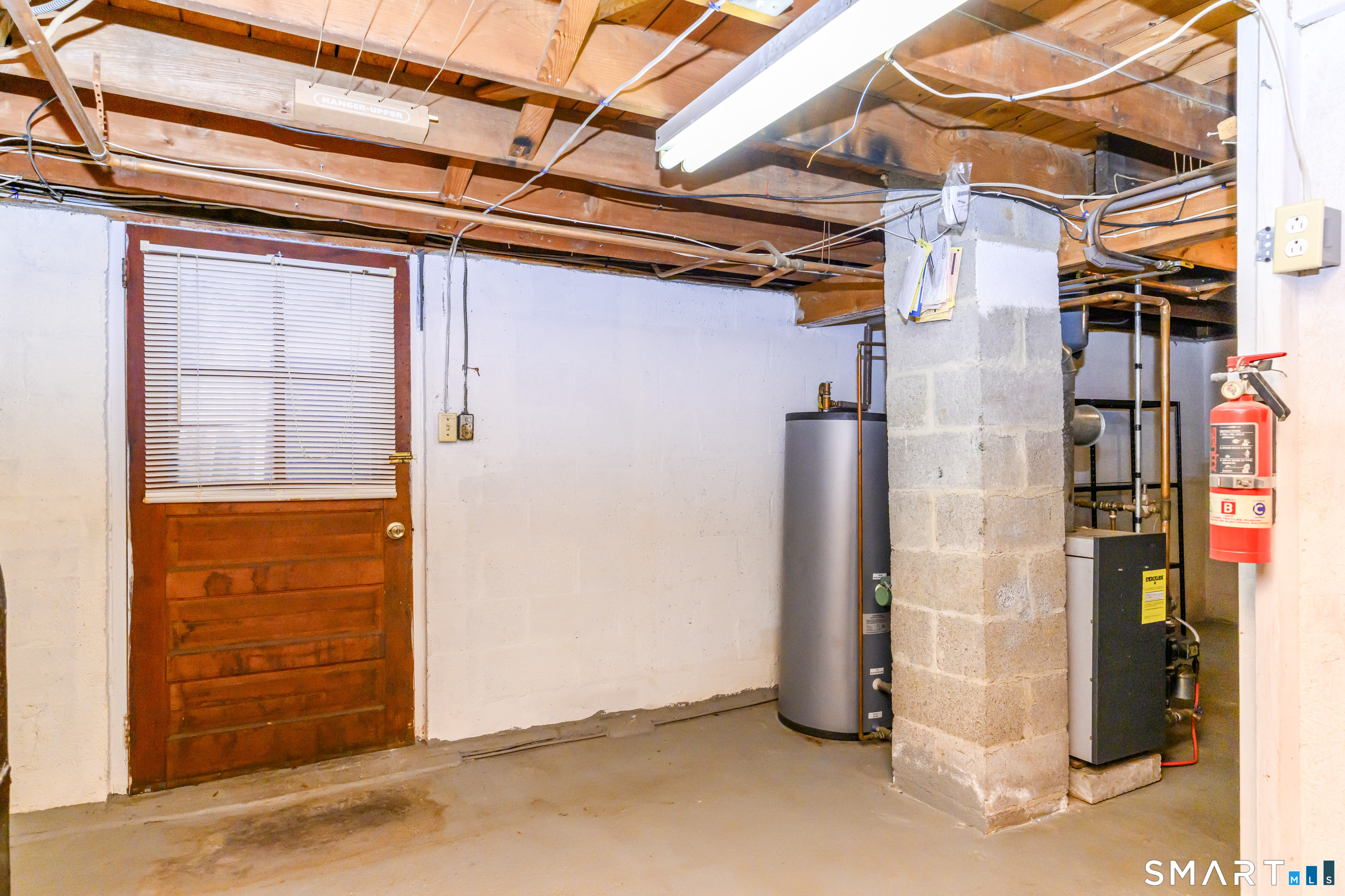 39 Rocky Ledge Drive Clinton, CT 06413 - Photo 30 of 40 Basement has full door leading to fenced-in side yard area with yet another shed.