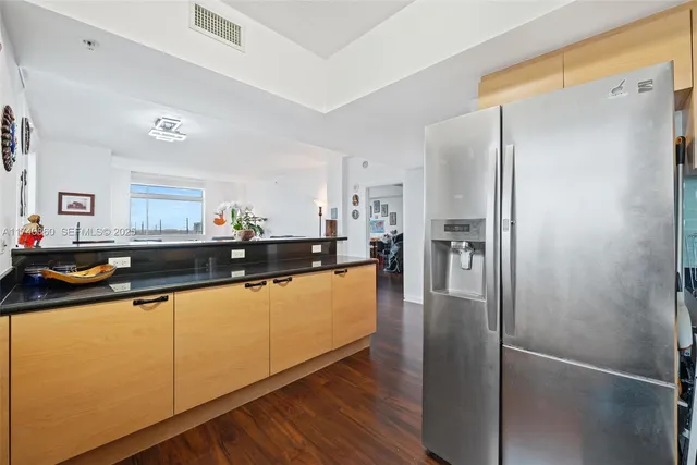 a kitchen with stainless steel appliances a refrigerator and a sink