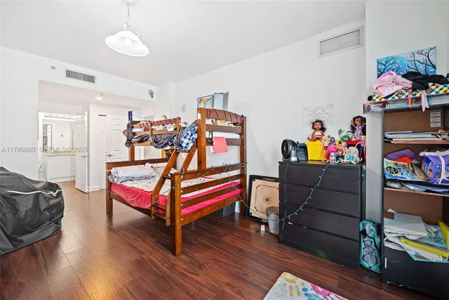 a bedroom with bed and a workspace