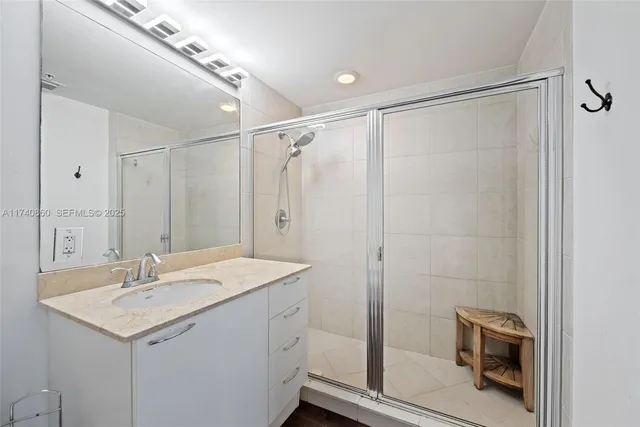 a bathroom with a sink a mirror and a shower