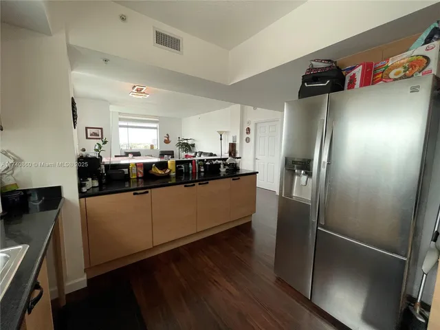 a kitchen with stainless steel appliances a refrigerator and a sink