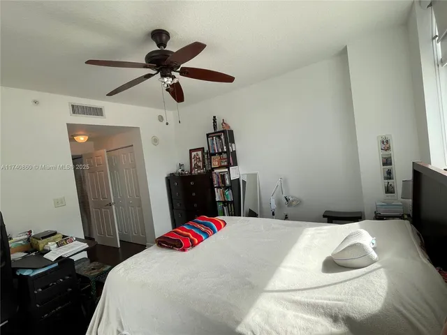 a bed room with a bed and a chandelier