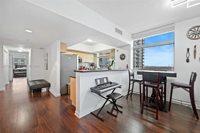 a view of a dining room with furniture and wooden floor