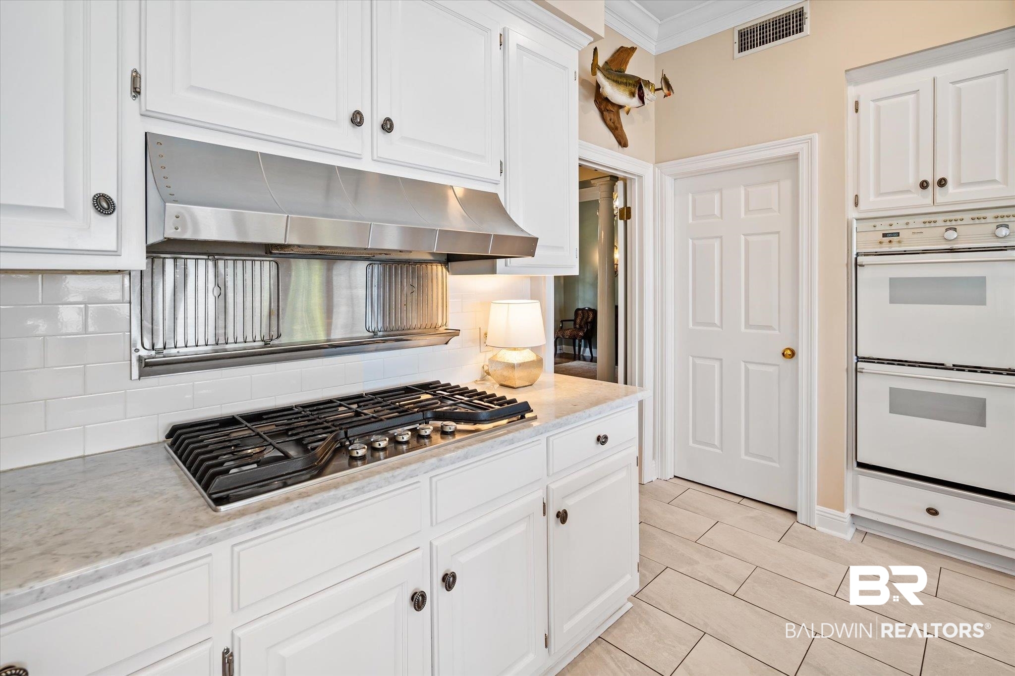 4930 River Trace Theodore, AL 36582 - Photo 11 of 57 Kitchen featuring double oven, decorative backsplash, crown molding, stainless steel gas stovetop, and white cabinetry