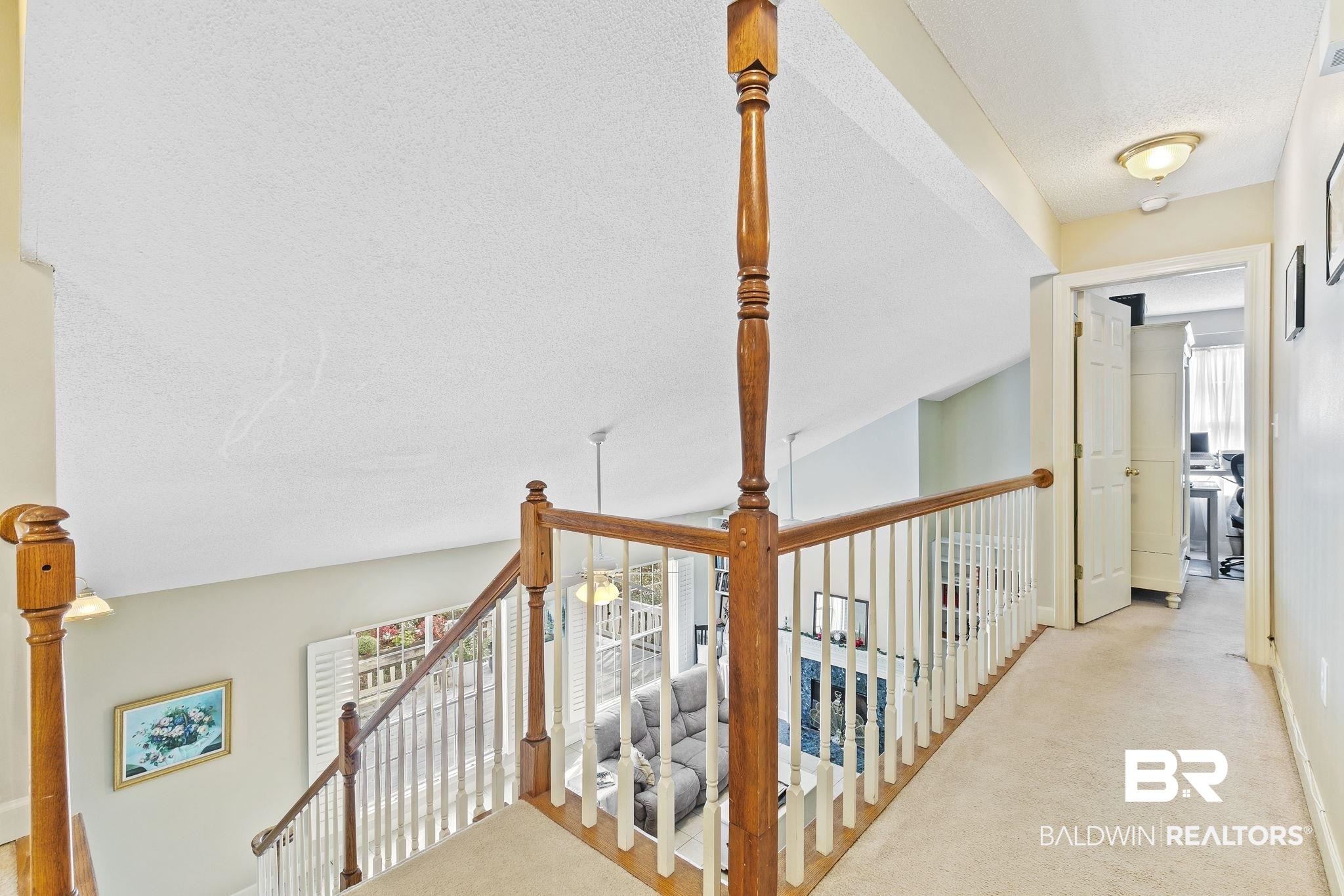 22 Pirates Lane Daphne, AL 36527 - Photo 22 of 36 Hallway with light carpet, a textured ceiling, and lofted ceiling