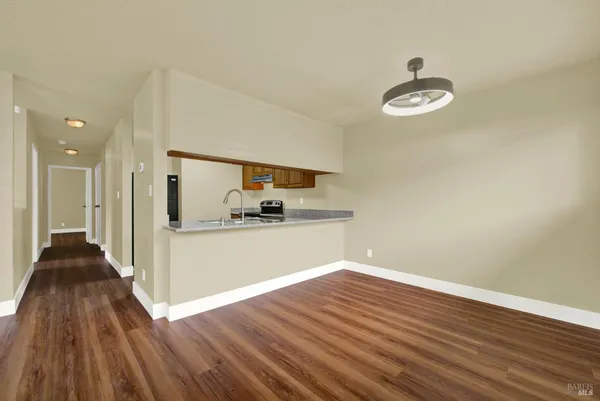 a kitchen with stainless steel appliances granite countertop a sink and a refrigerator