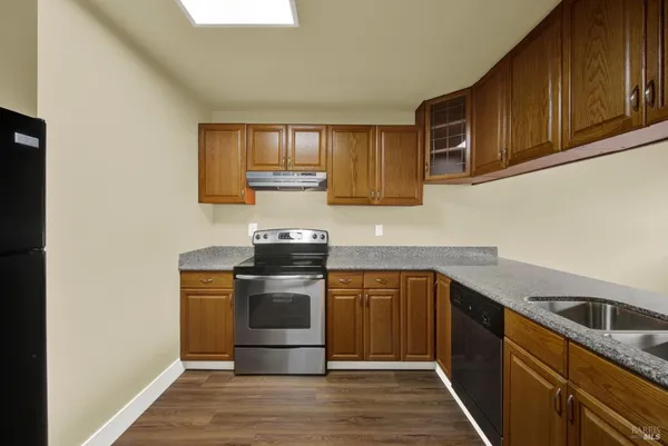 a view of a room with wooden floor and windows
