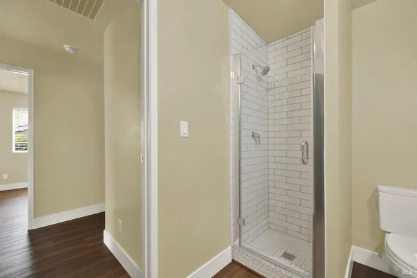 a bathroom with a granite countertop toilet a sink and a bathtub