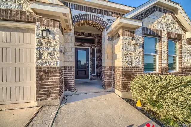 a view of a porch with a door and wooden floor