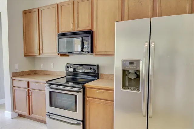 a view of a kitchen with a sink and a refrigerator