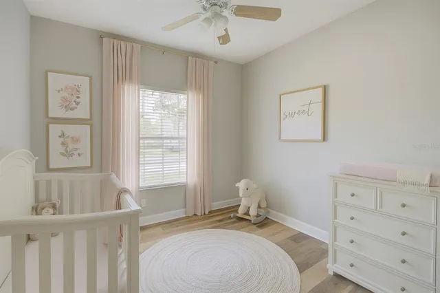 an empty room with wooden floor windows and a mirror