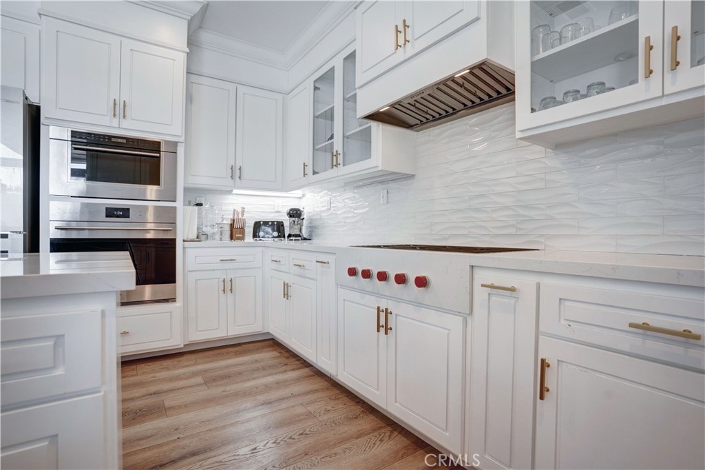 43041 Noble Court Temecula, CA 92592 - Photo 25 of 62 a kitchen with cabinets wooden floor and appliances