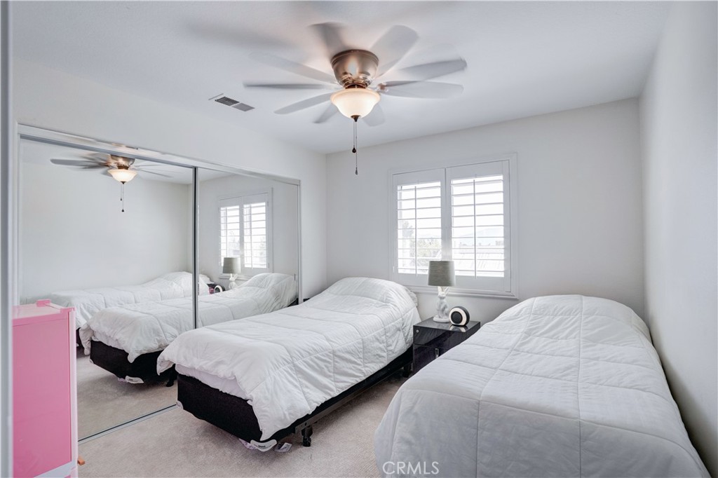 43041 Noble Court Temecula, CA 92592 - Photo 37 of 62 a bedroom with two beds and a chandelier