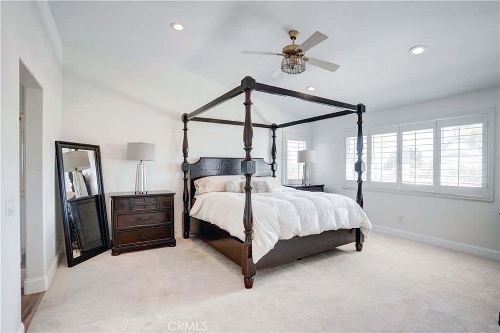 43041 Noble Court Temecula, CA 92592 - Photo 43 of 62 a bedroom with a bed chandelier and window