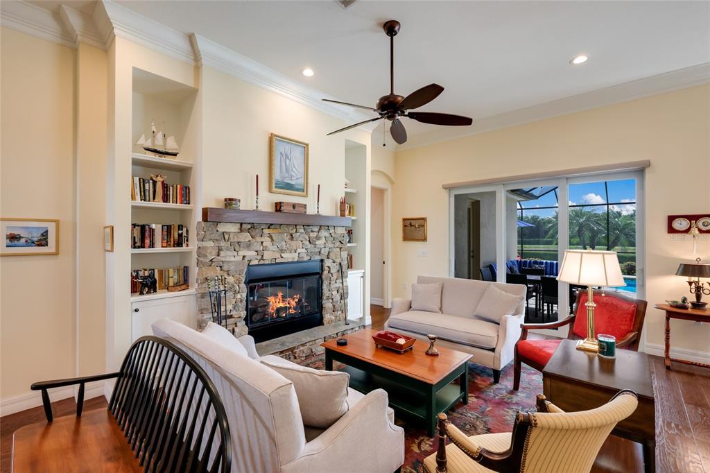 5011 Tobermory Way Bradenton, FL 34211 - Photo 7 of 77 a living room with furniture a fireplace and a flat screen tv