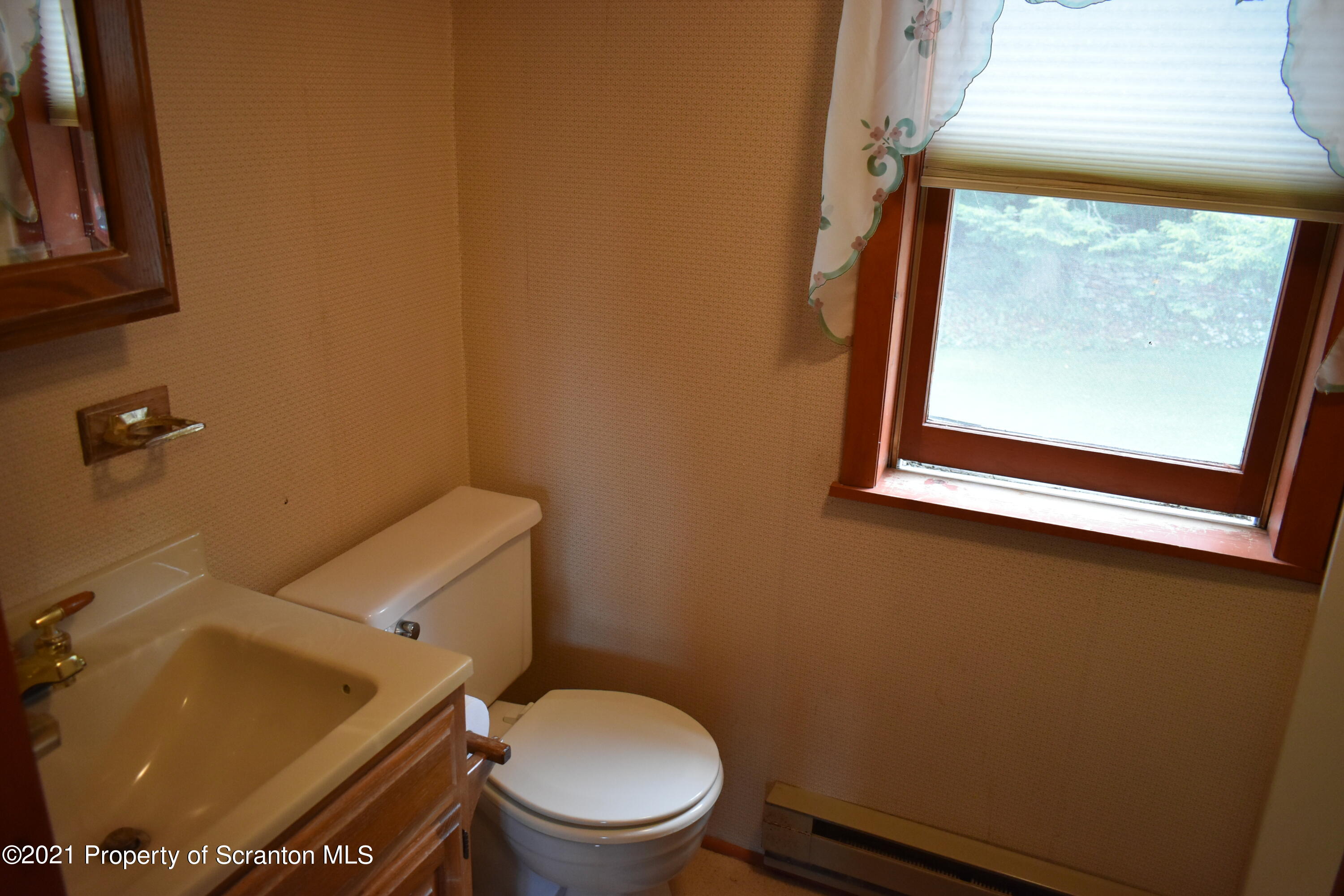 266 Baker Road Montrose, PA 18801 - Photo 13 of 28 a bathroom with a toilet a sink and a mirror