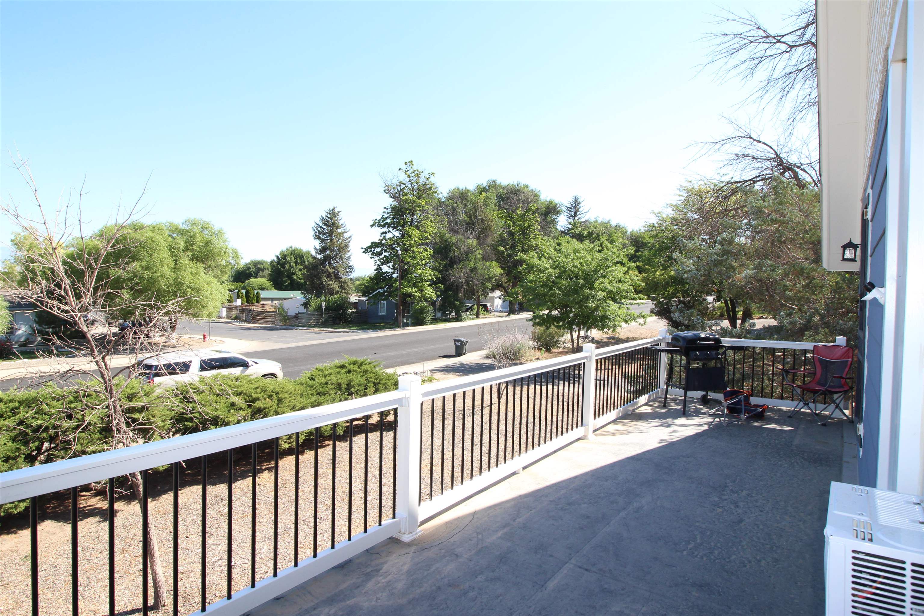 1150 East 7th Street Delta, CO 81416 - Photo 22 of 32 a view of a roof deck with wooden fence and trees
