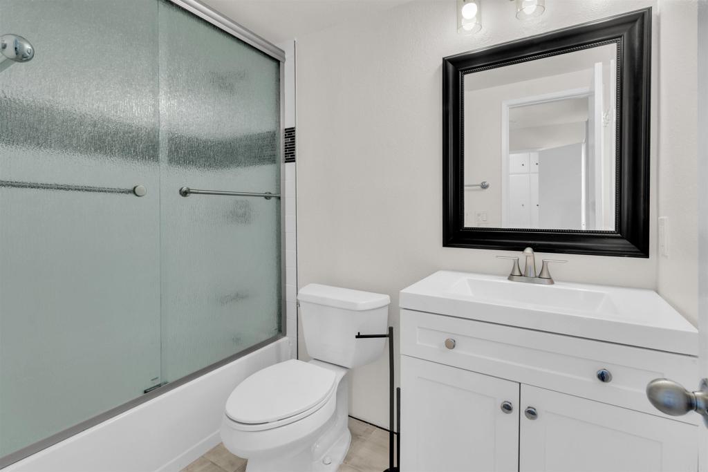 7321 Alicante Road, Unit A Carlsbad, CA 92009 - Photo 17 of 27 a bathroom with a toilet sink vanity and mirror
