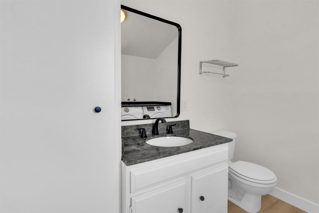 7321 Alicante Road, Unit A Carlsbad, CA 92009 - Photo 18 of 27 a bathroom with a sink toilet and mirror