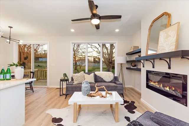 a living room with furniture a rug and a large window
