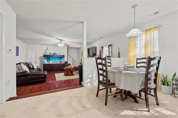 a living room with furniture a window and a chandelier
