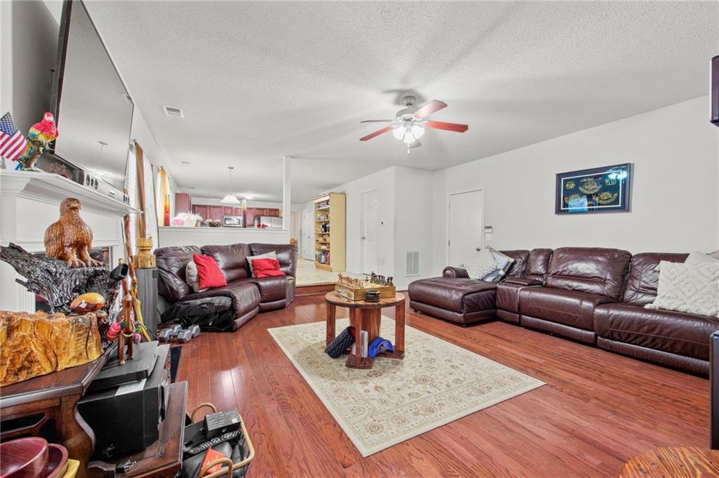 407 Grier Drive Locust Grove, GA 30248 - Photo 18 of 38 a living room with furniture and a chandelier