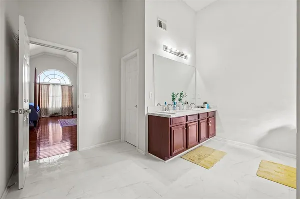 a bathroom with a tub sink and mirror