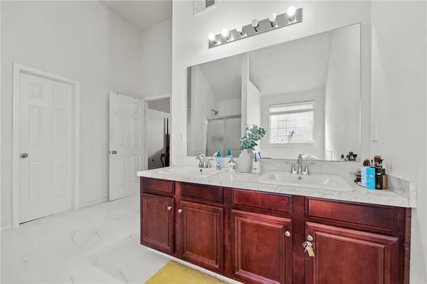 a bathroom with a double vanity sink and mirror