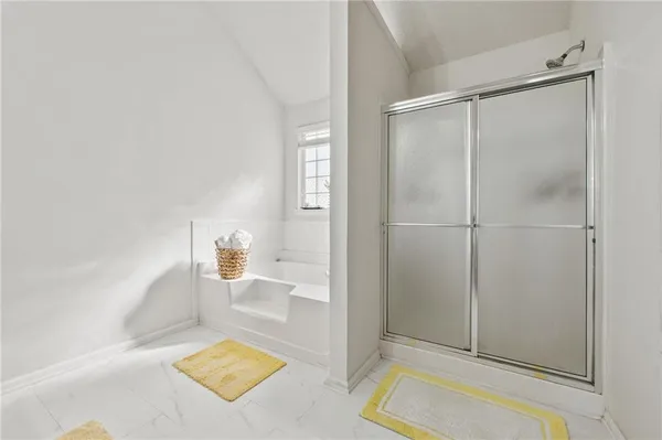 a bathroom with a bathtub and a shower