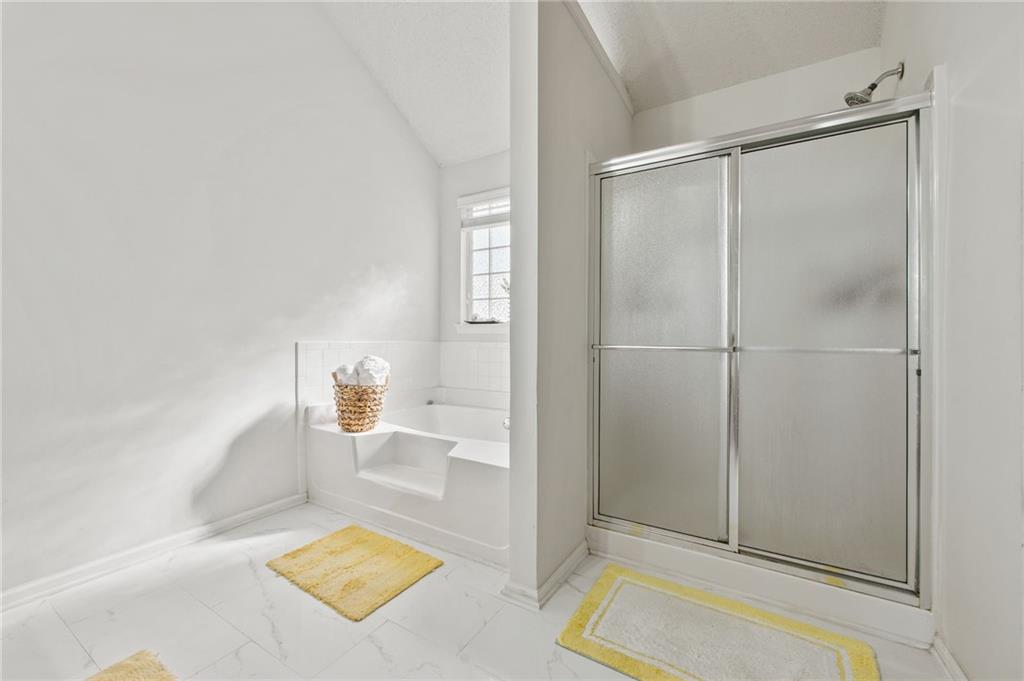 407 Grier Drive Locust Grove, GA 30248 - Photo 26 of 38 a bathroom with a tub and shower