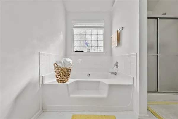 a bathroom with a tub sink and mirror