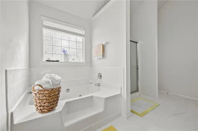 a view of walk in closet with clothes